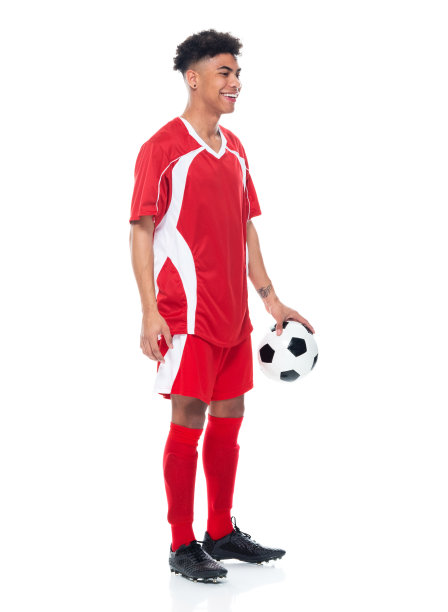 非裔美籍年轻男性运动员身穿足球制服站在白人背景前，手持足球进行足球运动和使用运动球图片下载