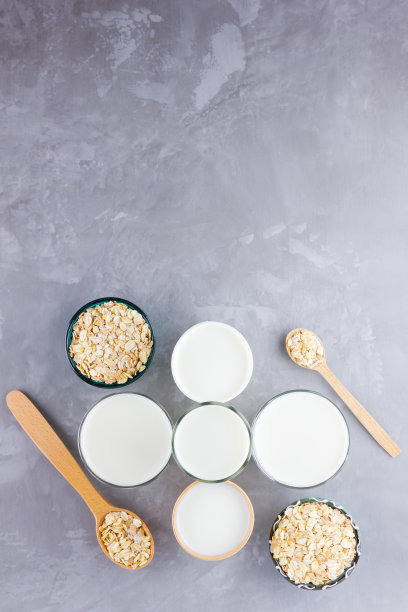 燕麦牛奶的概念。木架上的有机燕麦牛奶。素食非乳制品替代牛奶。水泥背景下的健康素食牛奶。“零浪费”。前视图。平躺图片下载