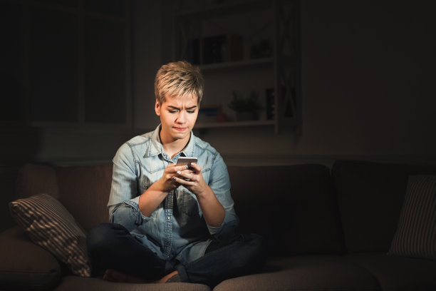 体贴的女孩晚上在家用手机发短信图片下载