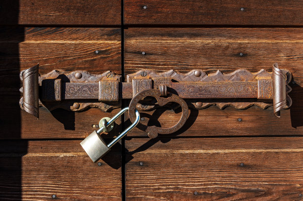 带有锻铁闩和挂锁的木门图片下载