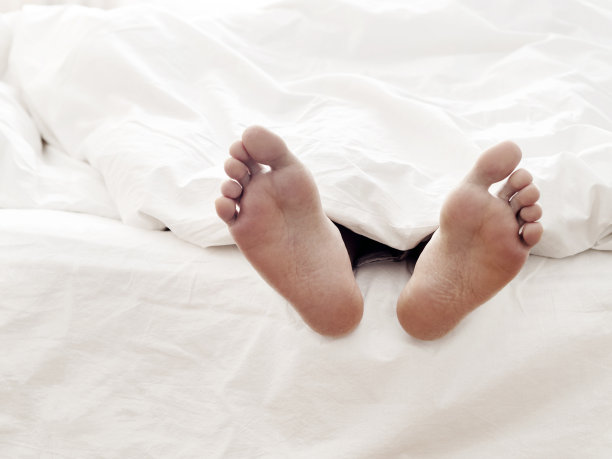 懒人和他的脚，躺在舒适的床上图片下载