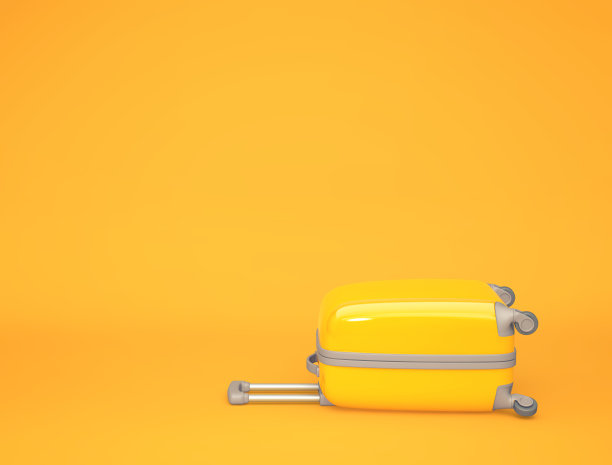 橙色背景的黄色旅行箱图片下载