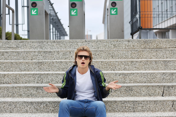 都市背景下迷人的青少年男孩，惊讶的青少年肖像图片下载