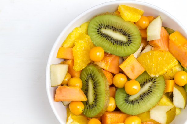 水果沙拉猕猴桃，醋栗，木瓜，菠萝，橙子和梨-近距离俯视图照片与拷贝空间图片下载