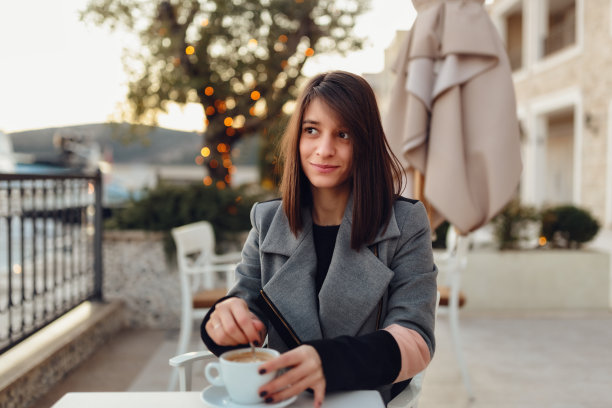 悠闲的女人在花园里喝咖啡图片下载