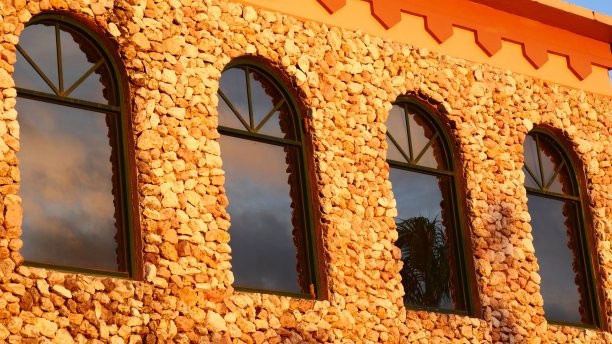 美丽的夕阳颜色反射在砖房的玻璃窗上图片下载