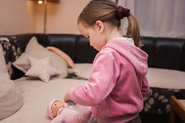 可爱的小女孩在玩洋娃娃图片下载