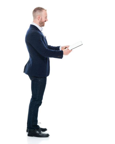 白人男性经理穿着牛仔裤站在白色背景前使用触摸屏图片下载