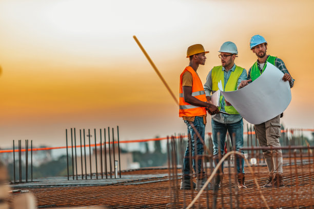 男建筑承包商在建筑工地给一群工人下达指令图片下载