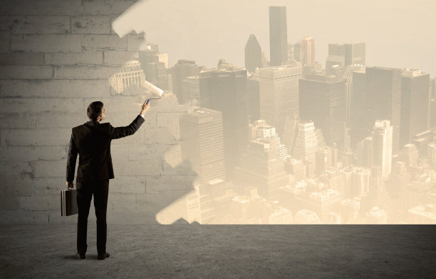 推销员在墙上画城市风景图片下载