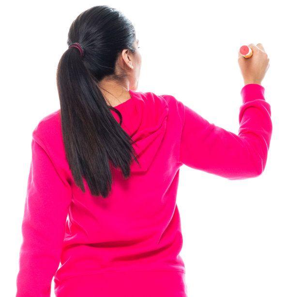 z一代女教师穿着运动衫，用铅笔站在白色背景前图片下载