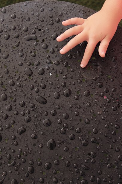 儿童的手和黑色的水面图片下载