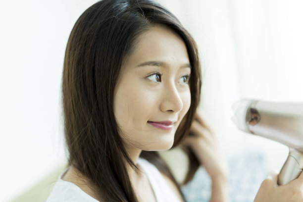 年轻女子在吹头发图片下载