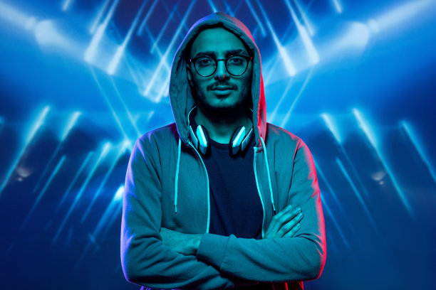 穿着帽衫、眼镜和t恤的年轻人双臂交叉放在胸前图片下载