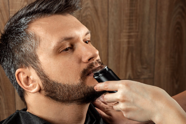 理发师用修剪器为顾客修剪鼻毛特写：理发店的日常护理图片下载