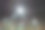 户外迷你足球场和篮球场，球门和篮筐环绕着高防护网，在夜晚被聚光灯照亮。图片下载