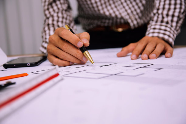 男建筑师在施工现场绘制蓝图图片下载