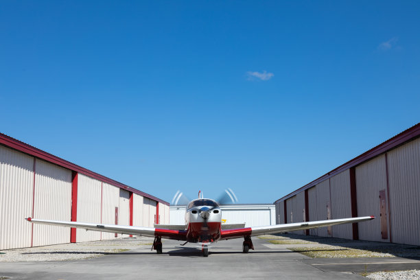 在机场机库之间的小型飞机图片下载