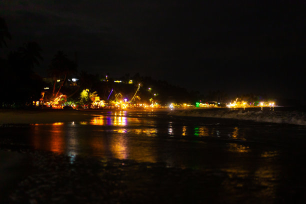 沙滩上有灯和桌子的海滨餐厅图片下载