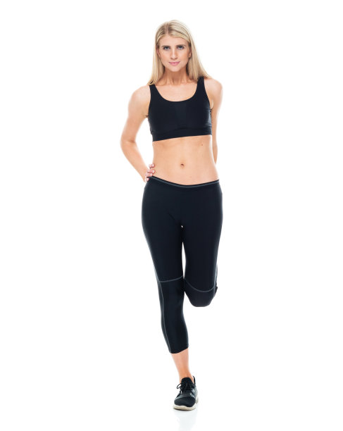 白人年轻女性运动员伸展在白色背景穿着运动胸罩图片下载