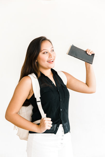 快乐沉思的女学生拿着笔记本打招呼图片下载