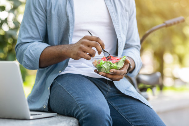 在公园户外享用健康午餐的非洲男人图片下载