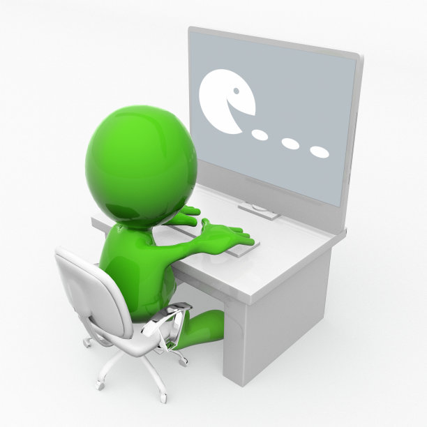 绿色的吉祥物在玩电脑游戏图片下载