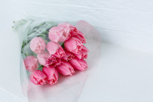 桌子上放着一束粉红色的郁金香，庆祝国际妇女节图片下载