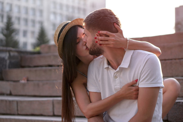 一对美丽的男人和女人在混凝土城市房屋的背景。一个女孩和一个男孩的浪漫主题。春天，夏天照片关系，爱情，情人节图片下载