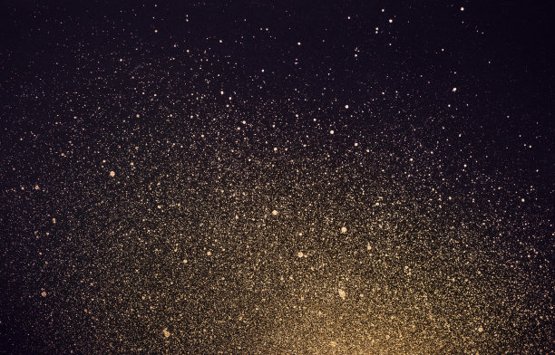 节日背景与金色光泽的油漆飞溅。抽象的宇宙图片下载