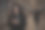 一个年轻漂亮的女人在晚上走过一个地下通道，后面跟着一个穿着深色衣服、戴着兜帽的男人。一位妇女试图拨打救援服务的电话图片下载