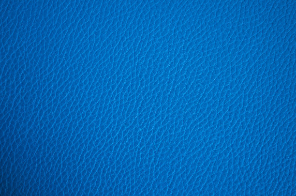 皮革纹理近。蓝色时尚背景，俯视图。时尚壁纸。海军蓝表面粗糙。图片下载