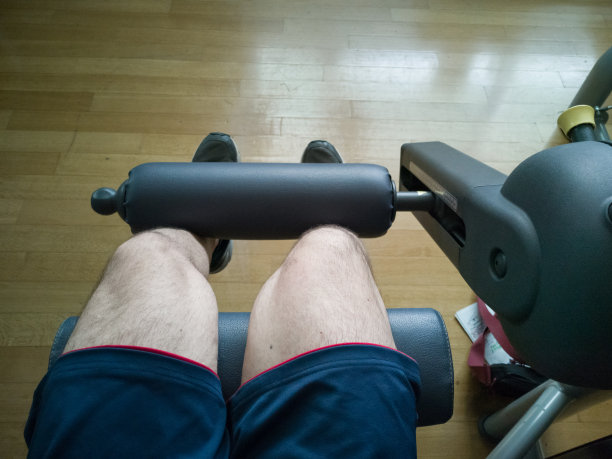 在健身房做运动:在健身机器上伸展腿，特色视图图片下载