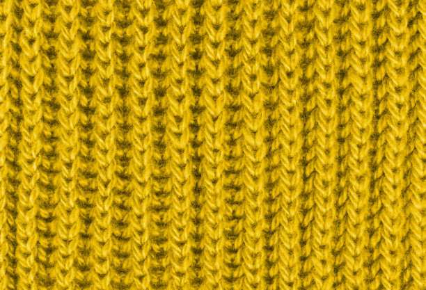 鲜艳的黄色纹理针织羊毛围巾。黄色纺织背景针织品。特写镜头图片下载