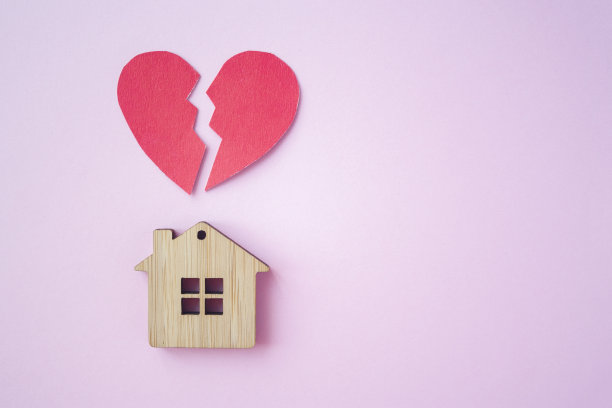 离婚，财产分割，贫穷和无钱的概念。带着破碎的心的木头房子在明亮的粉红色背景上。抵押贷款、租赁、房地产经纪人图片下载