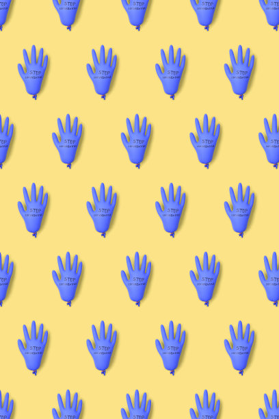 用乳胶外科或医用手套制成的图案，背景为黄色。图片下载