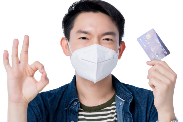 家庭健康保险概念：快乐的亚洲男性手持防护口罩和信用卡图片下载