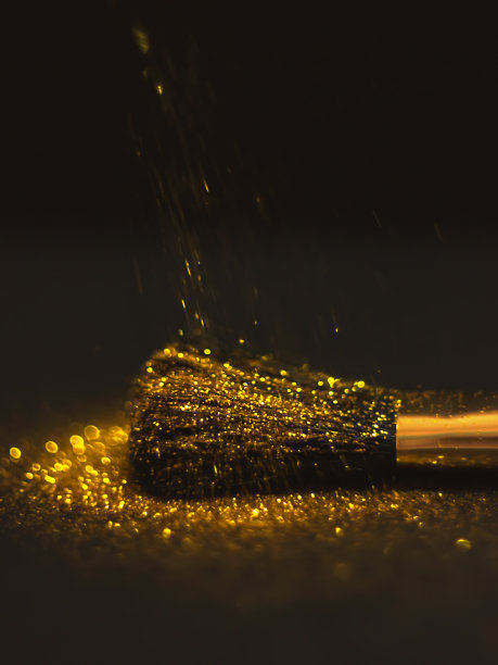 化妆刷和设计上的金色闪光纹理。在白色背景上。选择性聚焦-图像图片下载