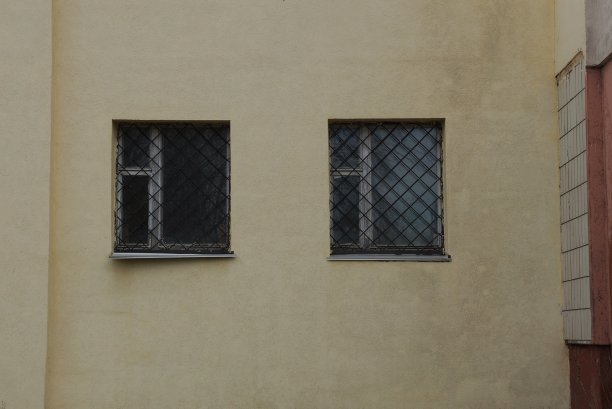 房子的棕色混凝土墙和两个灰色的窗户图片下载