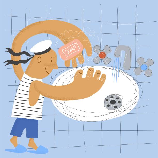 一个穿着水手服的男孩正在用肥皂洗手图片下载