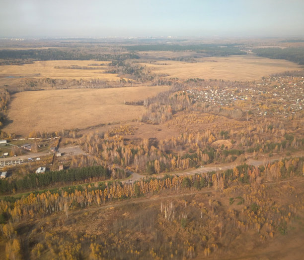 在一架飞机上飞过城市，从机翼上的窗口俯瞰旅游的游客图片下载
