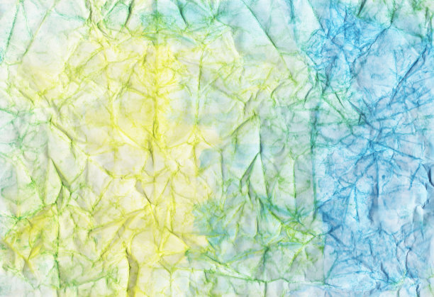 蓝色和黄色的皱巴巴的纸。沙黄色和海蓝色褶皱的背景。颜色抽象墙纸。丰富多彩的工艺页面。图片下载