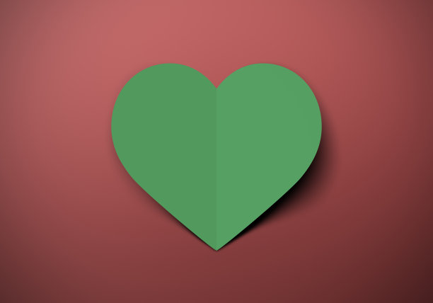 剪出绿色的心，在红色的表面投下阴影图片下载