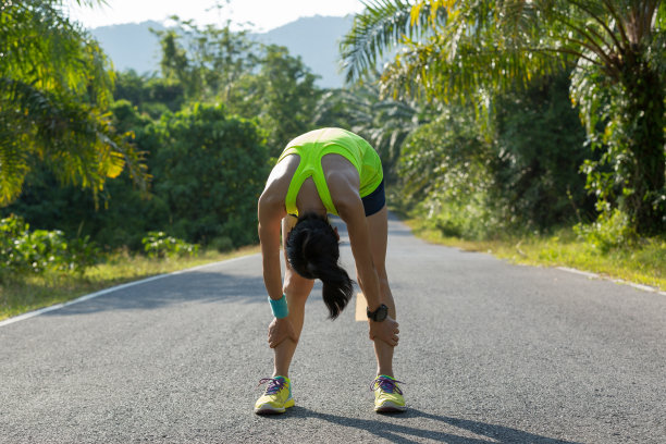 在热带森林小道上休息的年轻健身女性图片下载
