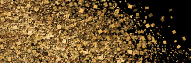 在黑色的背景下，金色颗粒的散射。摘要全景背景进行设计。图片下载