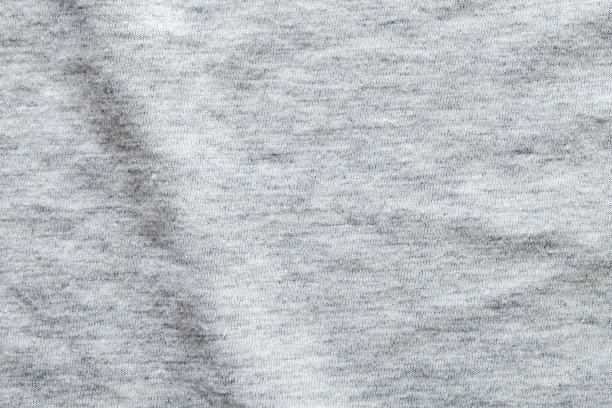 近距离拍摄，看细节的石南灰色针织织物制成的合成纤维背景。抽象的墙纸、服装或柔软的纺织品与文本复制空间。图片下载
