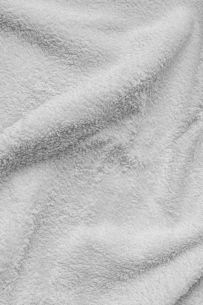 打褶的白色棉质材料。纹理或背景图片下载