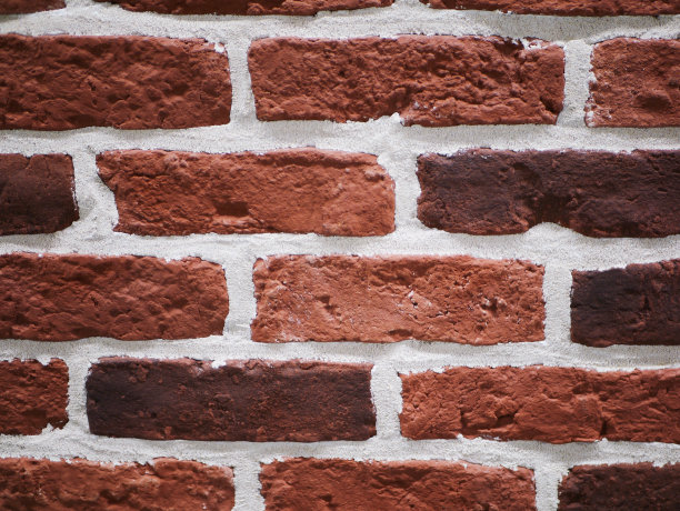 橙色砖外观。破石头纹理。石头墙。抽象的背景图片下载