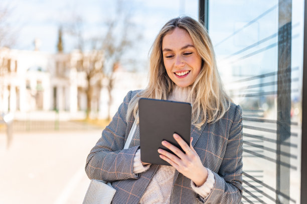 年轻女子使用数码平板电脑户外库存照片图片下载