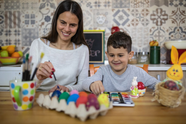 一个男孩和他的妈妈喜欢画复活节彩蛋的股票照片图片下载